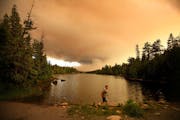 As the sun set over the Cavity Lake fire near the Gunflint Trail in 2006, a golden glow of smoke filled the air near the Trail’s end boat launch.