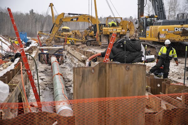 Workers laid down pipeline in February as part of Enbridge’s Line 3 project on the Fond Du Lac Native American Reservation in Cloquet.   ] ALEX KORM