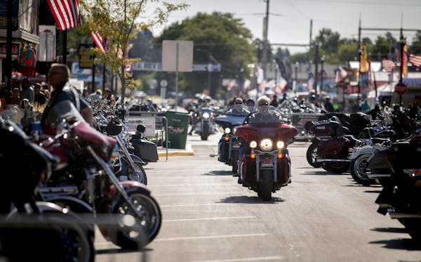 People rode through downtown Sturgis, S.D., last year during the 80th annual Sturgis Motorcycle Rally. [Grace Pritchett/Rapid City Journal via AP]