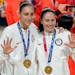 Sue Bird, right, and Diana Taurasi pose with their gold medals during the medal ceremony for women’s basketball at the 2020 Summer Olympics