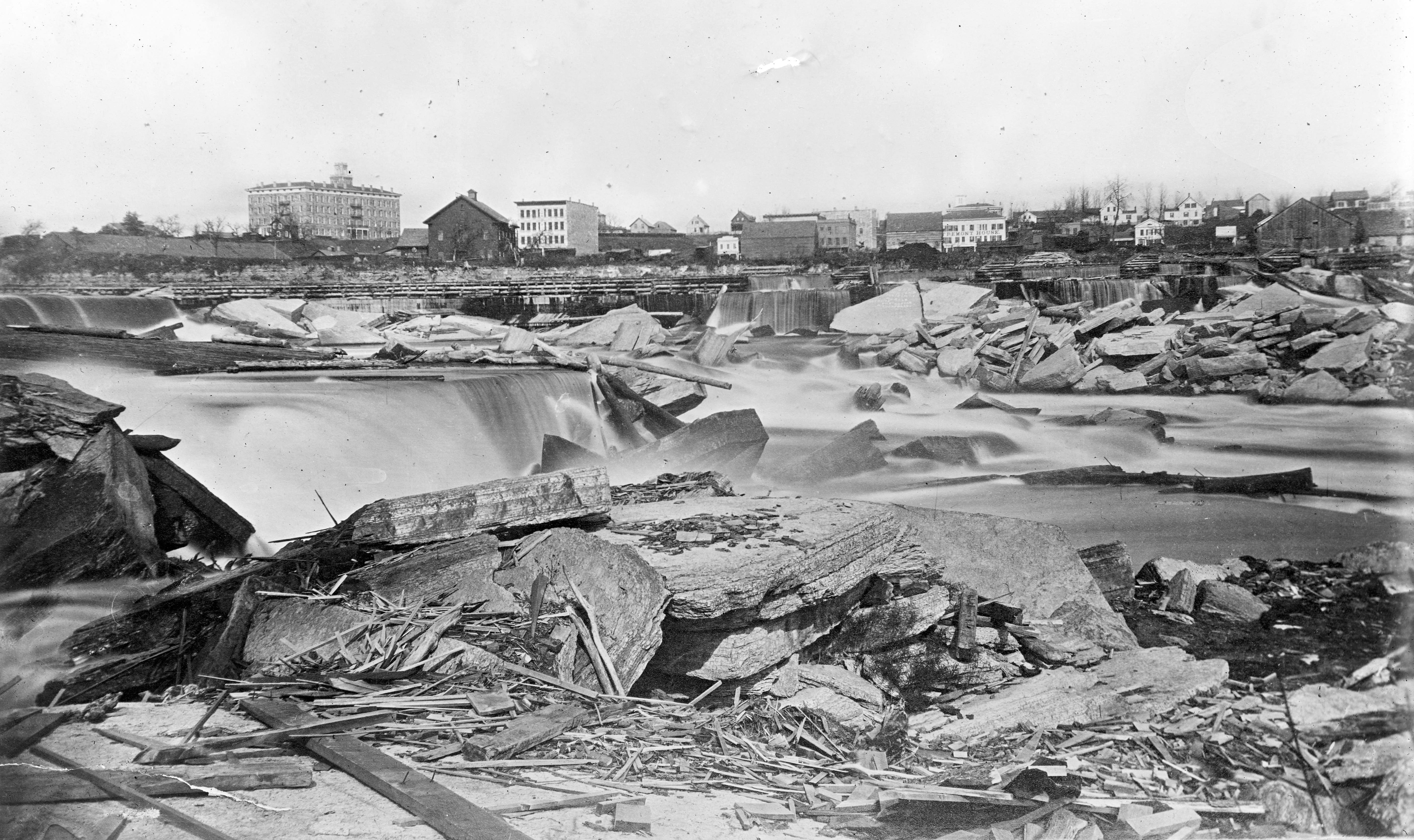 St. Anthony Falls in 1863, prior to the Eastman disaster and construction of a spillway. Sandstone erosion left chunks of broken limestone in the Mississippi River.