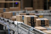 Packages move down a conveyor belt at Amazon’s fulfillment center in Shakopee. The retailer is planning a fourth Twin Cities site in Woodbury.
