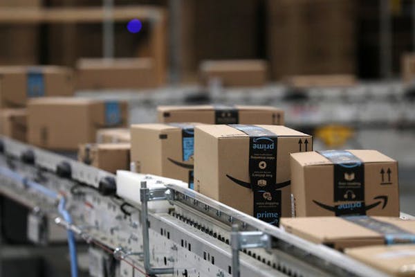 Packages passed down a conveyor belt before receiving a shipping label at Amazon’s fulfillment center in Shakopee.