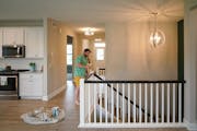James Kenna applied some touch-up paint to several areas inside the home in Dayton, Minn. he and his wife have put on the market. Home real estate tra