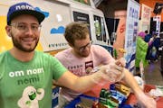 Two of Nomi’s founders Austin Hinkle, left, and Will Handke handed out samples at a food expo.