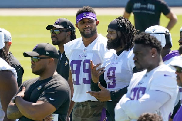 Vikings defensive end Danielle Hunter (99) and defensive tackle Sheldon Richardson (9) chat during minicamp in June.