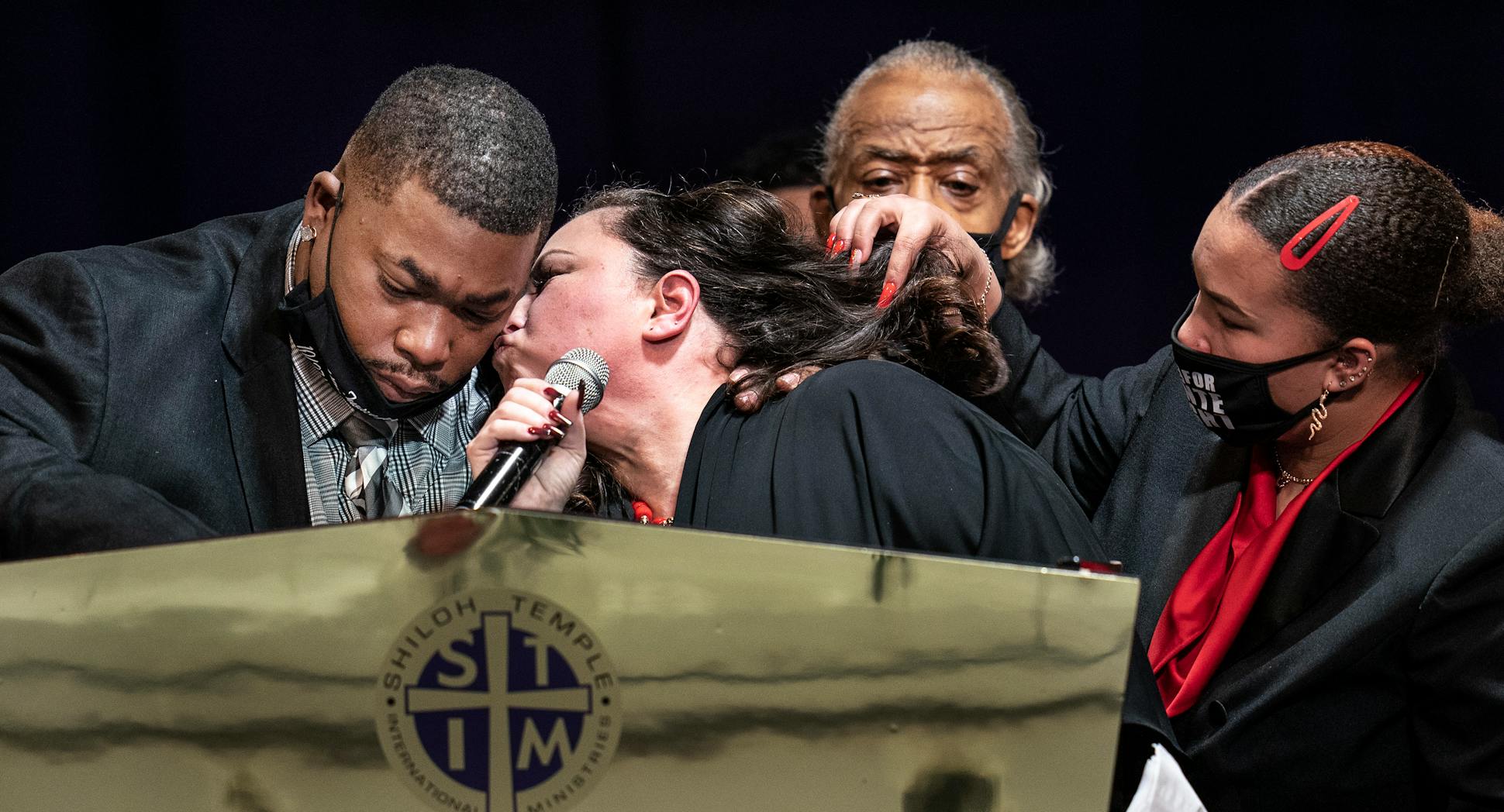 Katie Wright comforted her husband, Aubrey, at the funeral for their son Daunte at Minneapolis' Shiloh Temple on April 22. The Rev. Al Sharpton stood behind them. 