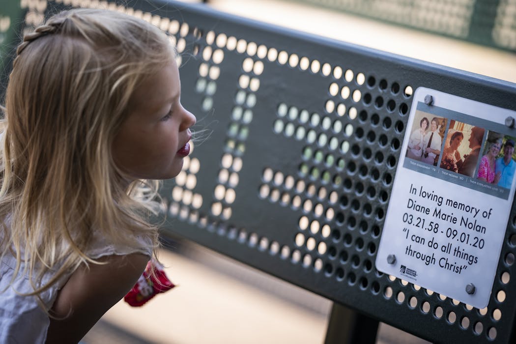 Quinn Hawkins, 2, looked at the bench dedicated to her late grandmother Diane Nolan. 