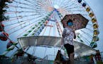 Justin Stafki, 17, of White Bear Lake, walked away from the Great Big Wheel after a ride with his mother, Barb, just as the rain started to fall Thurs