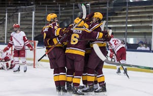 Gophers players celebrated after scoring against Wisconsin on their way to winning the 2021 Big Ten tournament championship.