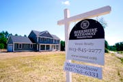 FILE - In this June 24, 2021 file photo, a real estate sign is posted in front of a newly constructed single family home in Auburn, N.H. U.S. home pri
