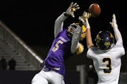 Cretin-Derham Hall defensive back Tre Holloman (5) makes a play on the ball during a 2019 game against Totino-Grace. Photo by Drew Herron, SportsEngin