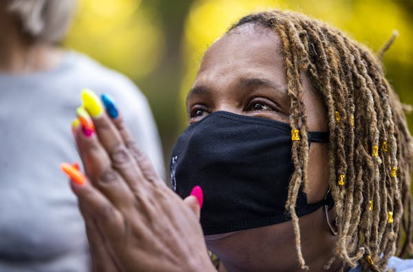 During an ice cream social in the Jordan neighborhood of Minneapolis, Audua Pugh held back tears as she talked with neighbors about a recent death in 