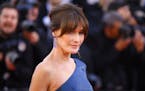 Former model Carla Bruni-Sarkozy poses for photographers upon arrival at the premiere of the film “Les Miserables” at the 72nd international film 