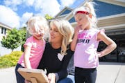 Mariah Jacobsen with her twin daughters outside their home in Northfield, Minn. Years after the 9/11 attack Jacobsen learned her birth father was Tom 