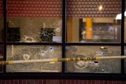 Bullet holes could be seen in the windows of the Clientele Barber Shop after a shooting there that left one man dead and another man and a woman injur