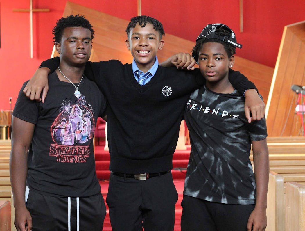 Cousins TJ Moody and Jadyn Galloway, both 15, and Michael Betts, 13, are all fans of Marvel Comics and say the film “Black Panther” empowered them to think they could be heroes in their own lives. Pictured here at Liberty Community Church in Minneapolis, the cousins said they hope that “Shang-Chi” will have the same effect on Asian American boys.