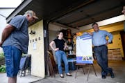 Robbinsdale resident Sam Good, left, looked at a map of the proposed Blue Line route Wednesday as he stood beside Anna Schmiel, a policy aide to the H