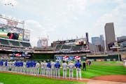 Four fighter jets fly over Target Field where players from the Twins and the Royals observed a moment of silence to mark the 20th anniversary of 9/11