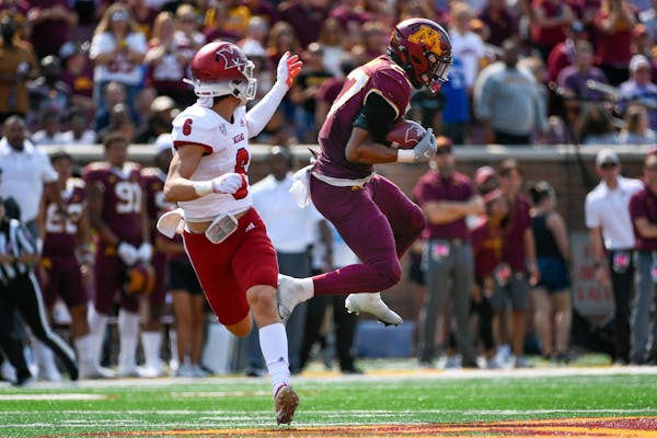 Minnesota defensive back Tyler Nubin, right, intercepts a pass intended for Miami-Ohio wide receiver Austin Robinson.