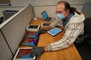 During distance learning last fall, Michael Schulze prepared several iPads to be deployed to students in the St. Paul district.