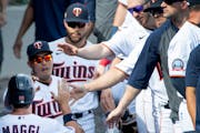 Drew Maggi, congratulated after scoring a run during Twins’ spring training in March, is in uniform for his first regular season game today, after 1