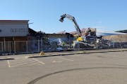 Crews started tearing down Midway Shopping Center in St. Paul on Tuesday.