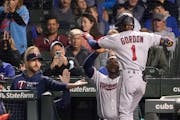 The Twins’ Nick Gordon reached the dugout to celebrate with manager Rocco Baldelli (left) and Miguel Sano after Gordon’s two-run homer off Cubs st