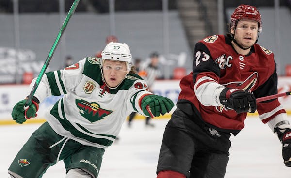 Kirill Kaprizov (97) of the Minnesota Wild and Oliver Ekman Larsson (23) of the Arizona Coyotes chased the puck in the first period. 

  


 
  