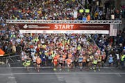 Runners head out at the start of the 2015 Twin Cities Marathon in Minneapolis. (AP Photo/Craig Lassig)