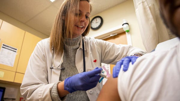 Nurse practitioner Kelly Moran gave a flu shot to a patient at a CVS Minute Clinic in Philadelphia in January 2020. 
