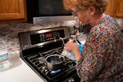 Monika Dipert filled her pot with bottled water to boil rice in her home in Andover, Minn., on Thursday, September 23, 2021. Dipert was shocked to lea