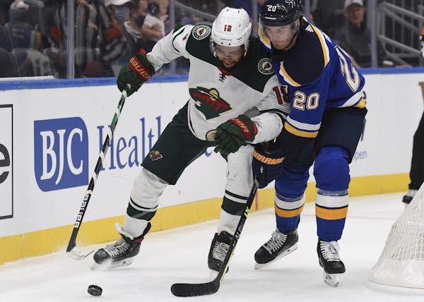 The Blues’ Brandon Saad (20) and the Wild’s Jordan Greenway battled for the puck in the first period of a preseason game.