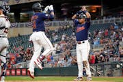 The Twins’ Jorge Polanco, left, celebrates his three-run home run off Detroit Tigers pitcher Casey Mize with teammate Luis Arraez