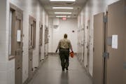 A deputy in the hallway of the intake area in the basement of the Hennepin County Jail. Dakota County is sending inmates to Wright County due to the s