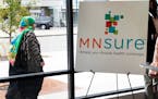 A woman walks an enrollment office for MNsure, the state’s health insurance marketplace for individual coverage.