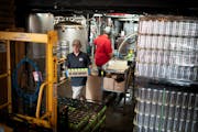 At Big Wood Brewery in White Bear Lake, Adam Engle and Jake Medvec canned and packaged containers of Fine IPA.  