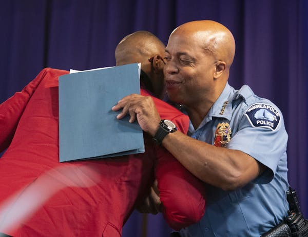 Police Chief Medaria Arradondo embraced PJ Hill, vice president of the Minneapolis chapter NAACP chapter, before speaking Saturday.