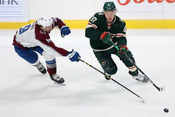 Wild star Kirill Kaprizov handled the puck while skating against Colorado’s Dennis Gilbert in the first period Monday night at Xcel Energy Center.