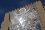 A mosaic mural nicknamed “Touchdown Jesus” is on the facade of the Hesburgh Library at Notre Dame in South Bend, Ind.