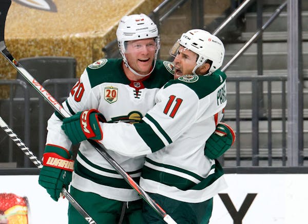 Ryan Suter #20 and Zach Parise #11 of the Minnesota Wild celebrate after Suter assisted Parise on a first-period goal against the Vegas Golden Knights
