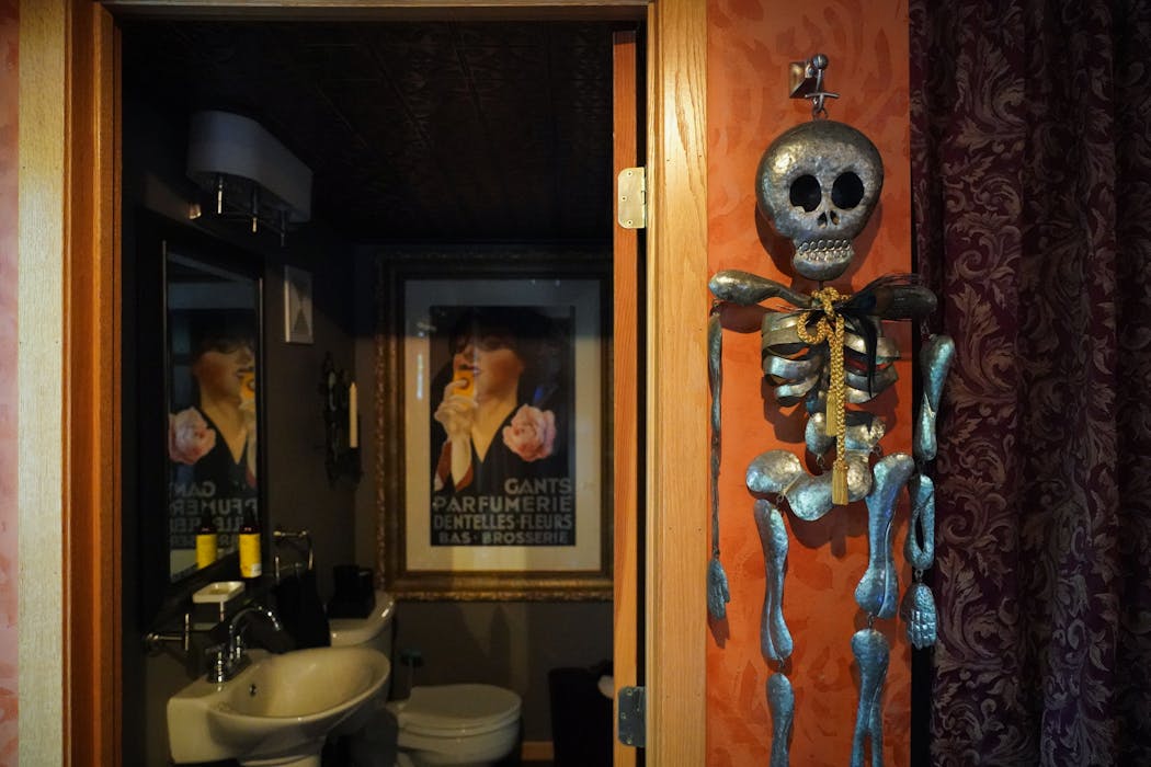 Skeleton decor hangs outside the bathroom in Richard Anderson’s home.