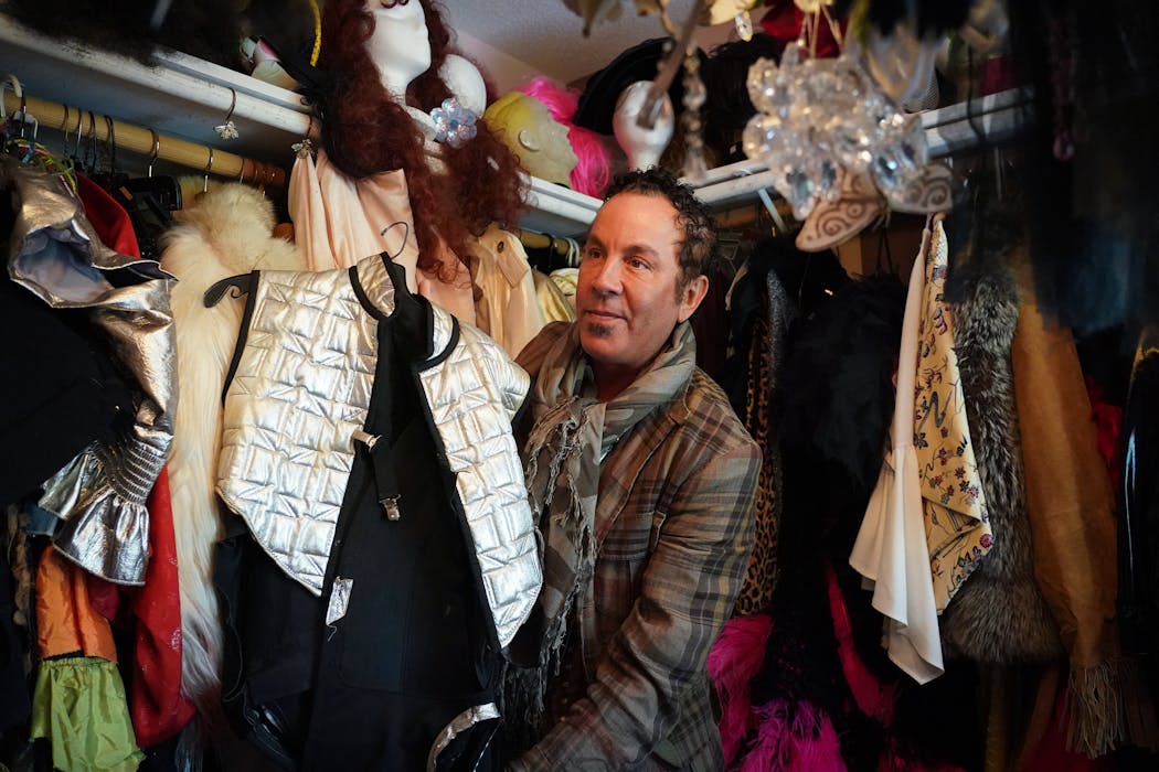 Richard Anderson shows off clothing in the wardrobe room dedicated to his drag queen persona, Miss Flowers.