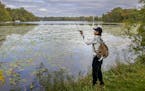 caption kicker Chue Lee, cq, who fishes at the park at least twice a week, fished for bass at Keller Regional Park, Thursday, October 7, 2021 in Maple