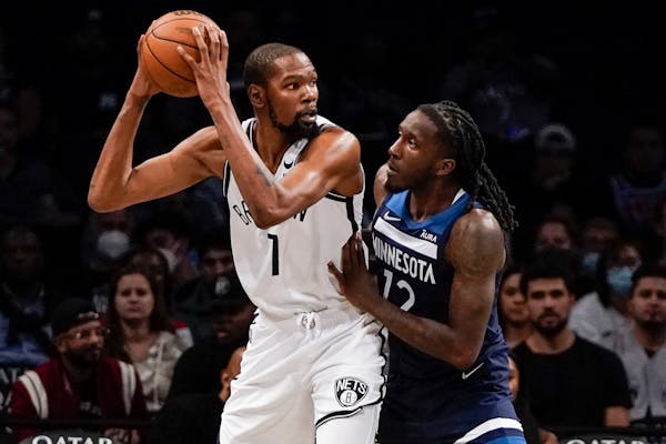 The Timberwolves’ Taurean Prince, right, defends against Brooklyn Nets’ Kevin Durant during the first half of a preseason game Thursday