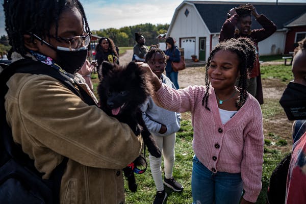 Skylar Edmon, 9, right, enjoyed meeting Hero, a Pomeranian owned by Keeyonna Fox. They are part of Black Homeschool Scholars with Swagg, a Twin Cities