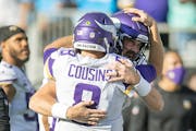 Vikings quarterback Kirk Cousins celebrates Sunday’s win with Nate Stanley. 