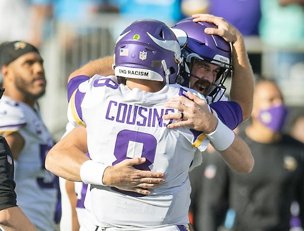 Vikings quarterback Kirk Cousins celebrates Sunday’s win with Nate Stanley. 
