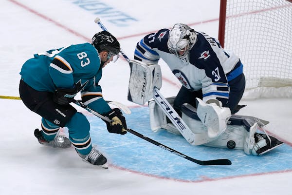 Jets goaltender Connor Hellebuyck stopped a shot by the Sharks’ Matt Nieto on Saturday night in San Jose.