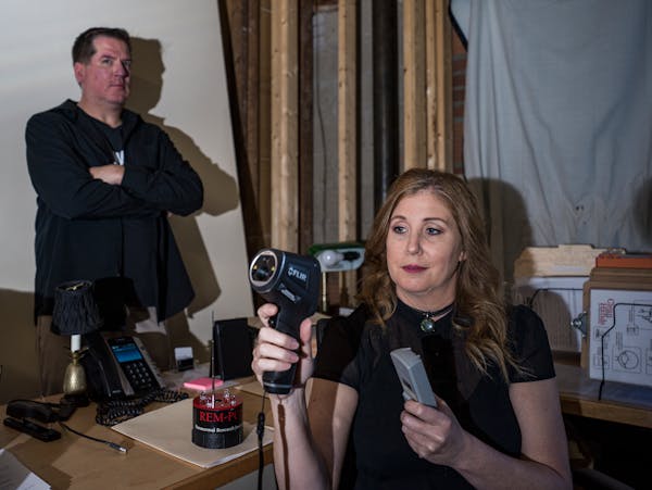 Dawn McClain and Brady Jeunesse, members of the Twin Cities Paranormal Society, in the attic office of the Lexington Restaurant in St. Paul, where the